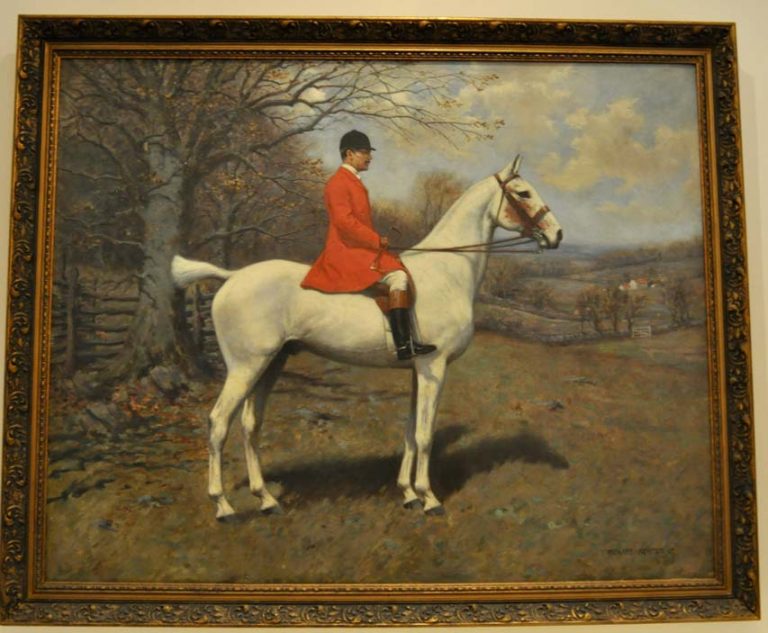 Framed oil painting of Mr. Maddow, MFH in foxhunting attire on a white horse standing in the field.