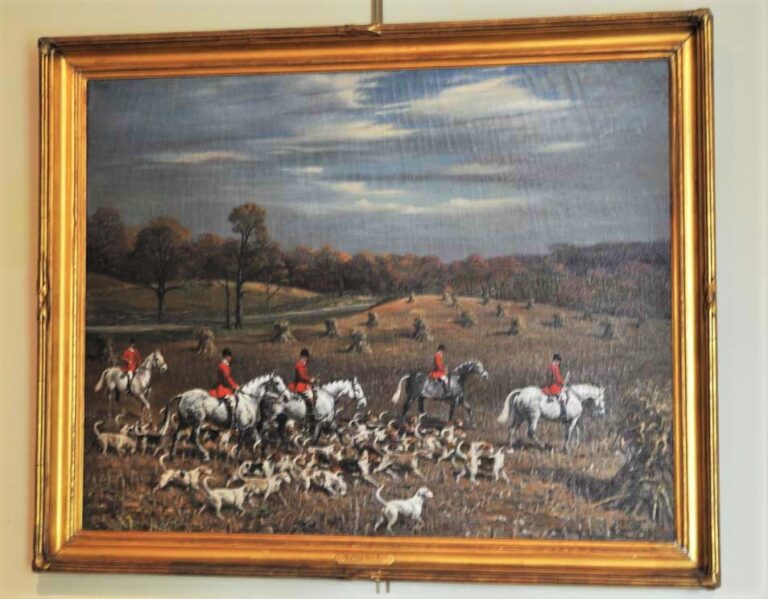 Oil Painting "The Meadowbrook" depicting a foxhunting scene with riders and foxhounds in an open field on display at the MHHNA
