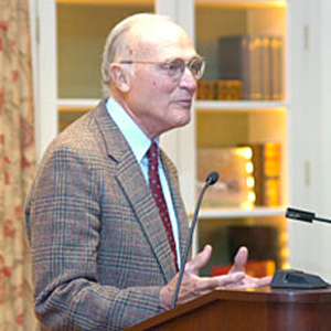 Peter Winants standing at a pulpit and speaking