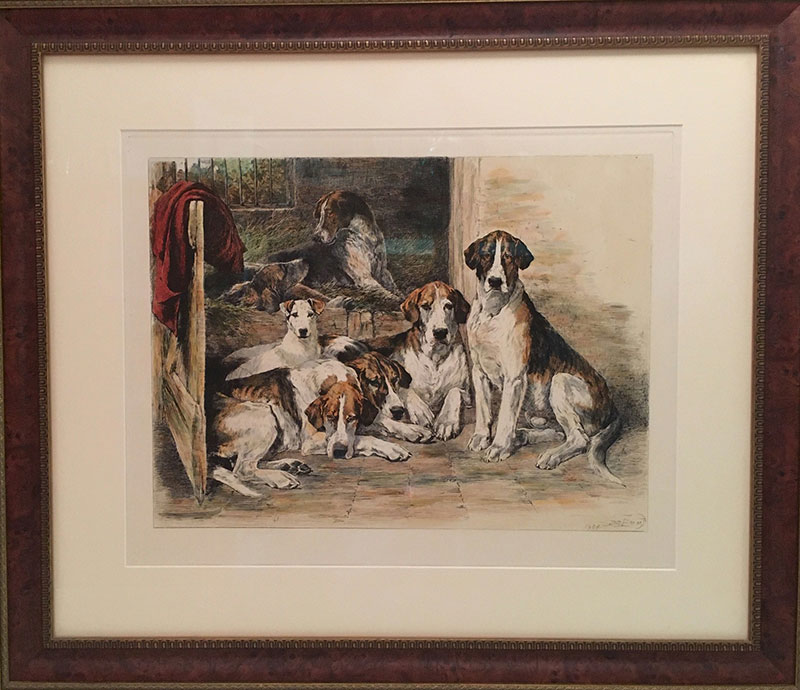 Framed and matted print by John Emms of a pack of foxhounds resting in the barn, donated by Bruce McCashin