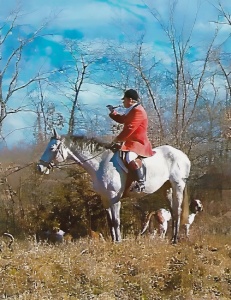 Huntsman on horse, blowing horn