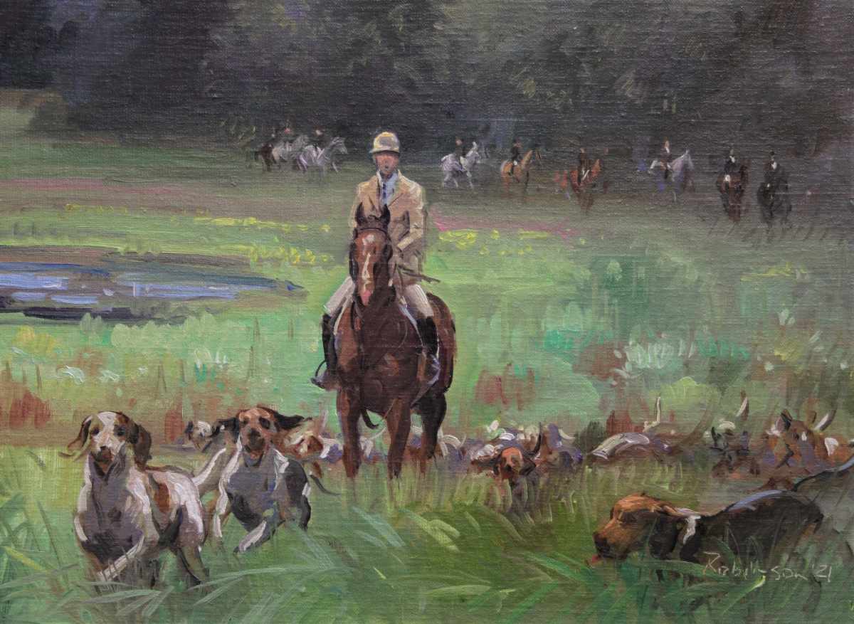 Hunt walking through field with hounds