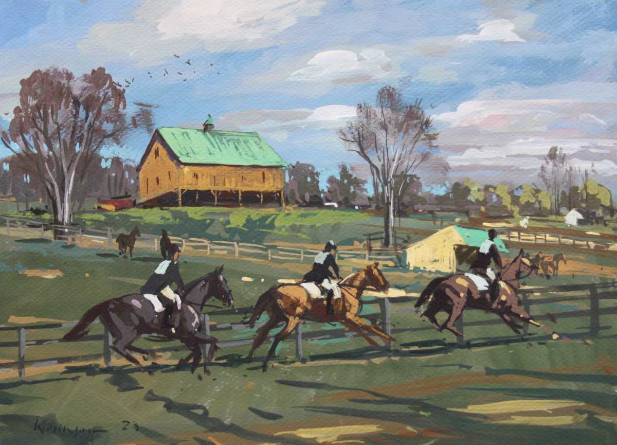 Three hunt riders and horses galloping along fenceline