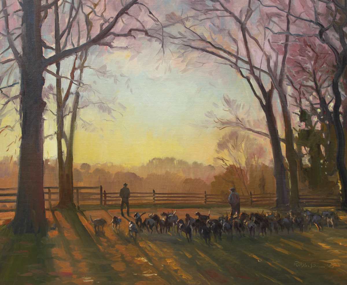 Two men standing with hounds at sunrise
