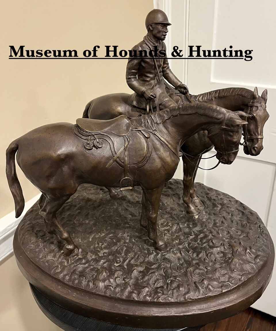 Bronze of horse and rider next to another horse