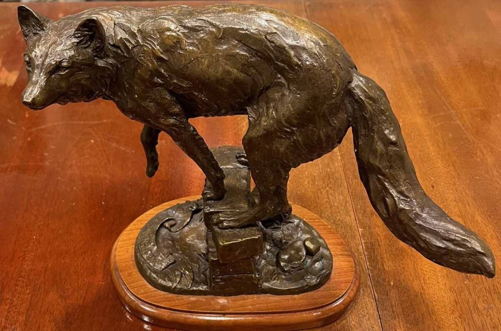 Bronze of fox preparing to leap