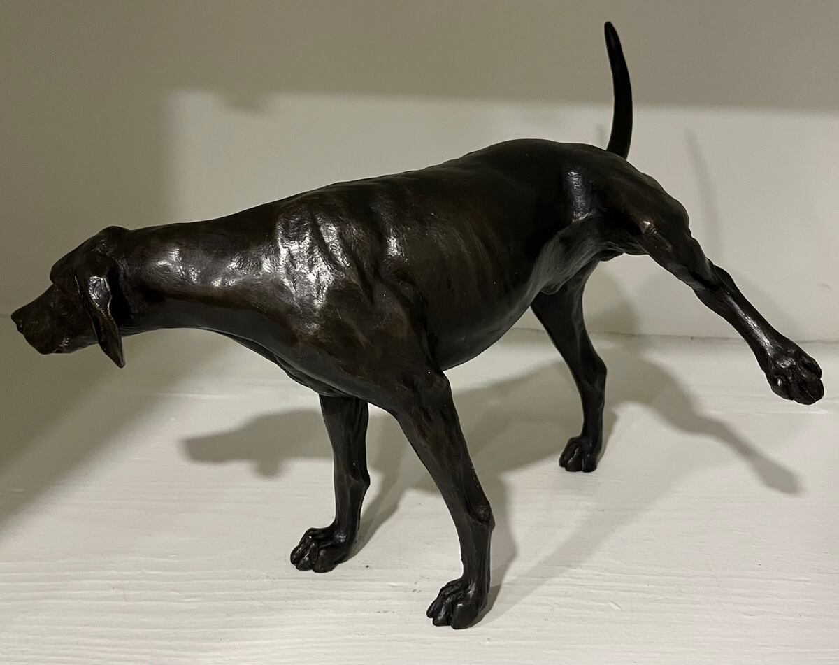 Bronze of hound lifting hind leg