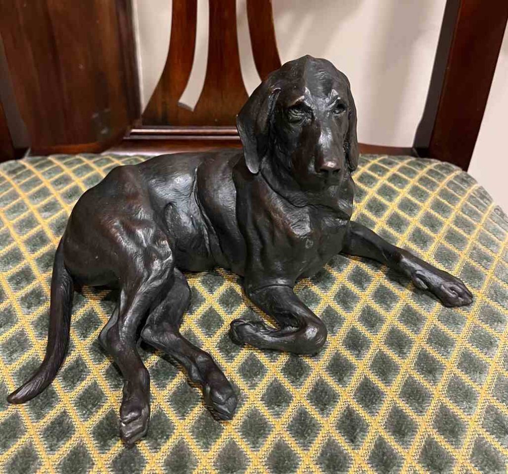 Bronze of hound laying down