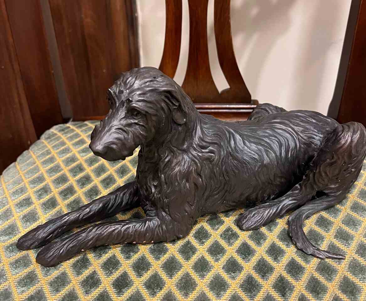 Bronze of hound laying down