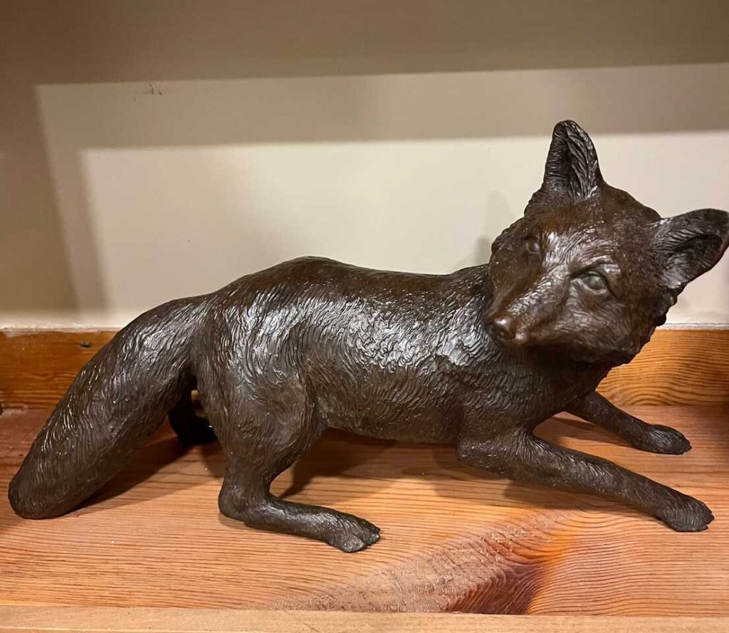 Bronze of fox laying down