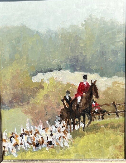 Hunt riders and hounds cresting a hill