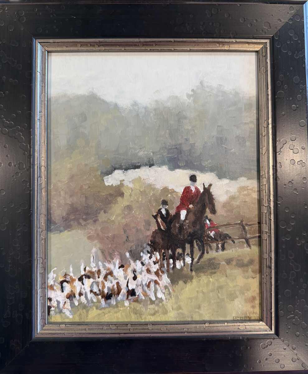 Hunt riders and hounds cresting a hill