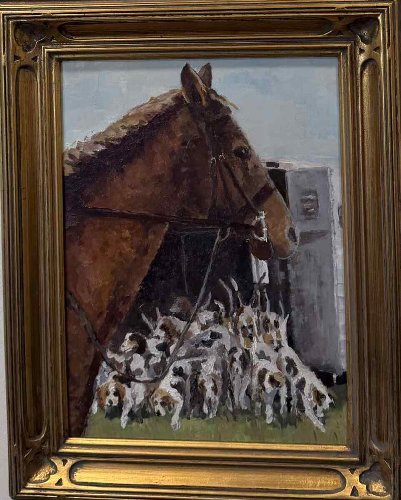 Horse standing while hounds spill out of vehicle.